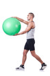 Man with swiss ball doing exercises on white