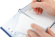 Close-up of hand beginning to write on notes