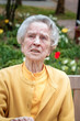 Happy oldere woman sitting outdoors
