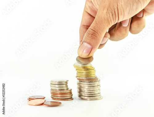 Photo: Stack of coins with hand on Stack of coins with hand on