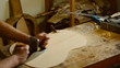 Luthier working with a wood planer in a flamenco guitar