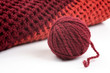 Knits and a ball of wool on a white background