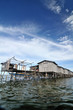 Bajau fisherman's wooden hut on sea water with blue sky