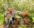 Photo: Happy parents and child with harvested vegetables Happy parents and child with harvested vegetables