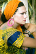 Woman with the african pigtails and by a tattoo on a shoulder