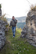 A young man on phone during a mountain excursion
