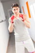 Boxer with red gloves in a gym