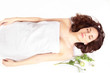 Young woman in relaxing spa, top view copy space