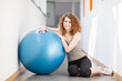 Young woman doing exercise with a gym ball