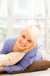 Smiling woman with short hairs laying on a pilow