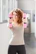 Young woman doing exercise with dumbbells