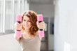 Young woman doing exercise with dumbbells