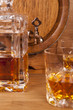 glass of whiskey, carafe and barrel