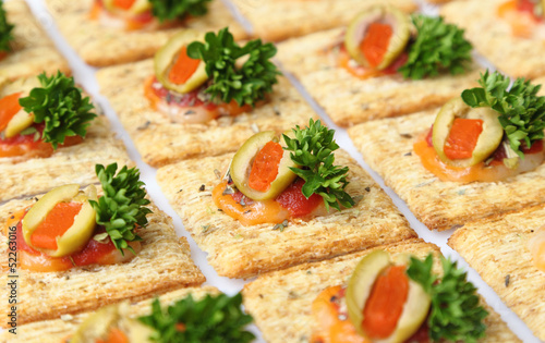 Photo: Baked wheat crackers topped with cheese, olives, and parsley Baked wheat crackers topped with cheese, olives, and parsley