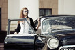 Foto: Young woman with retro car Young woman with retro car