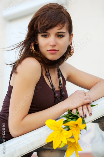 Photo: Sad young woman with a flowers Sad young woman with a flowers