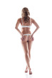 Slim model in white lingerie posing back to camera