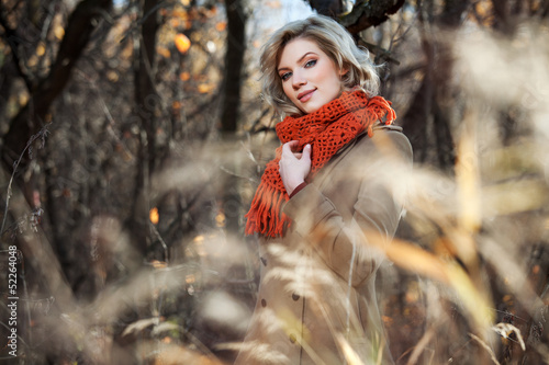 Photo: Young woman walking in autumn forest Young woman walking in autumn forest