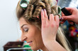 Photo: Woman at the hairdresser curling hair Woman at the hairdresser curling hair