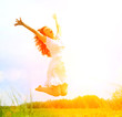 Happy Young Woman Jumping over blue sky. Beauty Girl Having Fun