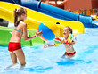 Child on water slide at aquapark.