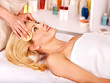 Foto: Woman getting facial massage . Woman getting facial massage .