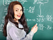 Schoolchild writing on blackboard.
