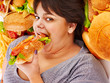 Photo: Woman eating hot dog. Woman eating hot dog.
