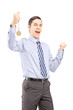 Foto: Excited young professional man gesturing happiness with medal in Excited young professional man gesturing happiness with medal in