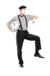 Full length portrait of a mime artist holding a clock and checki