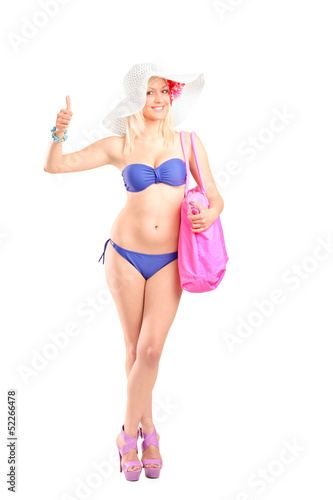 Photo: Full length portrait of an attractive blond woman in bikini givi Full length portrait of an attractive blond woman in bikini givi