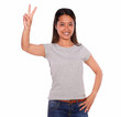 Photo: Ethnic smiling young woman celebrating a victory Ethnic smiling young woman celebrating a victory