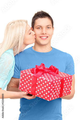 Photo: Young woman kissing a man with a present box Young woman kissing a man with a present box