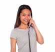 Photo: Smiling ethnic young woman conversing on phone Smiling ethnic young woman conversing on phone