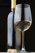white wine glass and bottle with cork
