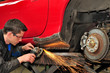 Photo: Man grinding welded car body. Man grinding welded car body.