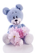 blue teddy bear stuffed animal with pink blossom.