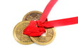 Three Chinese coins tied with red ribbon.