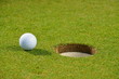 Golf ball on lip of cup
