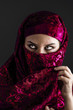 Photo: Arab women with traditional red veil, eyes intense, mystical bea Arab women with traditional red veil, eyes intense, mystical bea