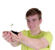 Foto: Teenager mit junger Pflanze Teenager mit junger Pflanze