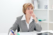 Thinking mature businesswoman