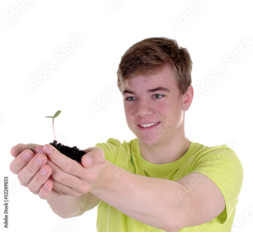 Photo: Teenager mit junger Pflanze Teenager mit junger Pflanze