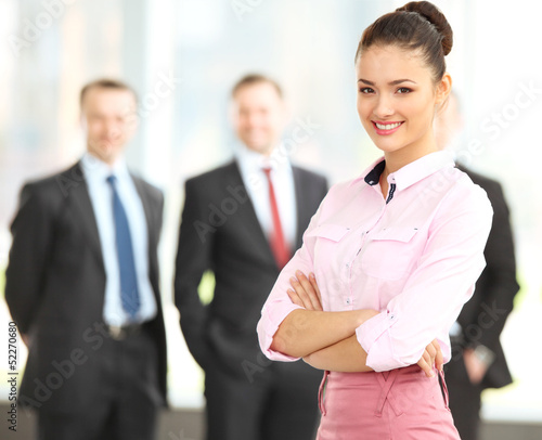 Photo: Female Business leader standing in front of her team Female Business leader standing in front of her team