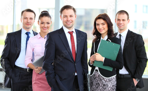 Photo: professional business team looking confidently at camera professional business team looking confidently at camera