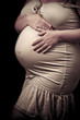 Photo: Portrait of pregnant woman touching her belly with hands Portrait of pregnant woman touching her belly with hands