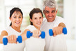 Photo: portrait of fit family having fun with dumbbells portrait of fit family having fun with dumbbells