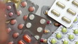 Hand picking up blister packagings with pills
