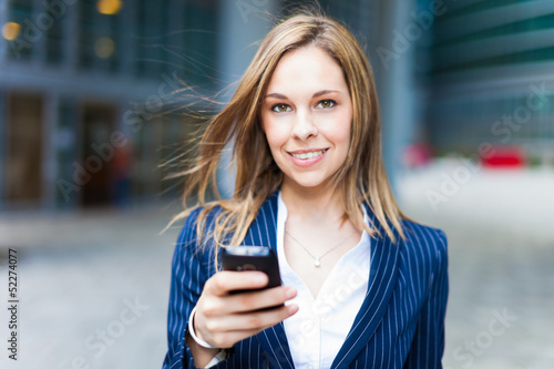 Photo: Woman using a cell phone Woman using a cell phone