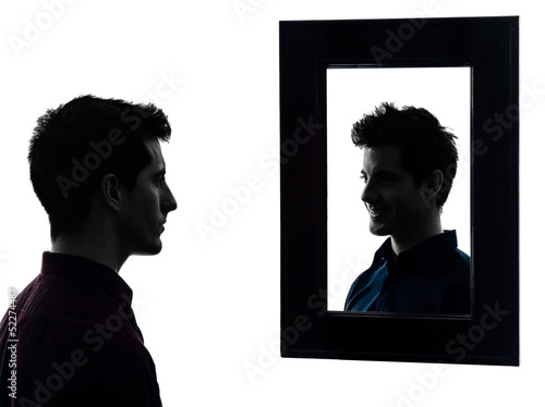 Photo: man serious in front of his mirror silhouette man serious in front of his mirror silhouette